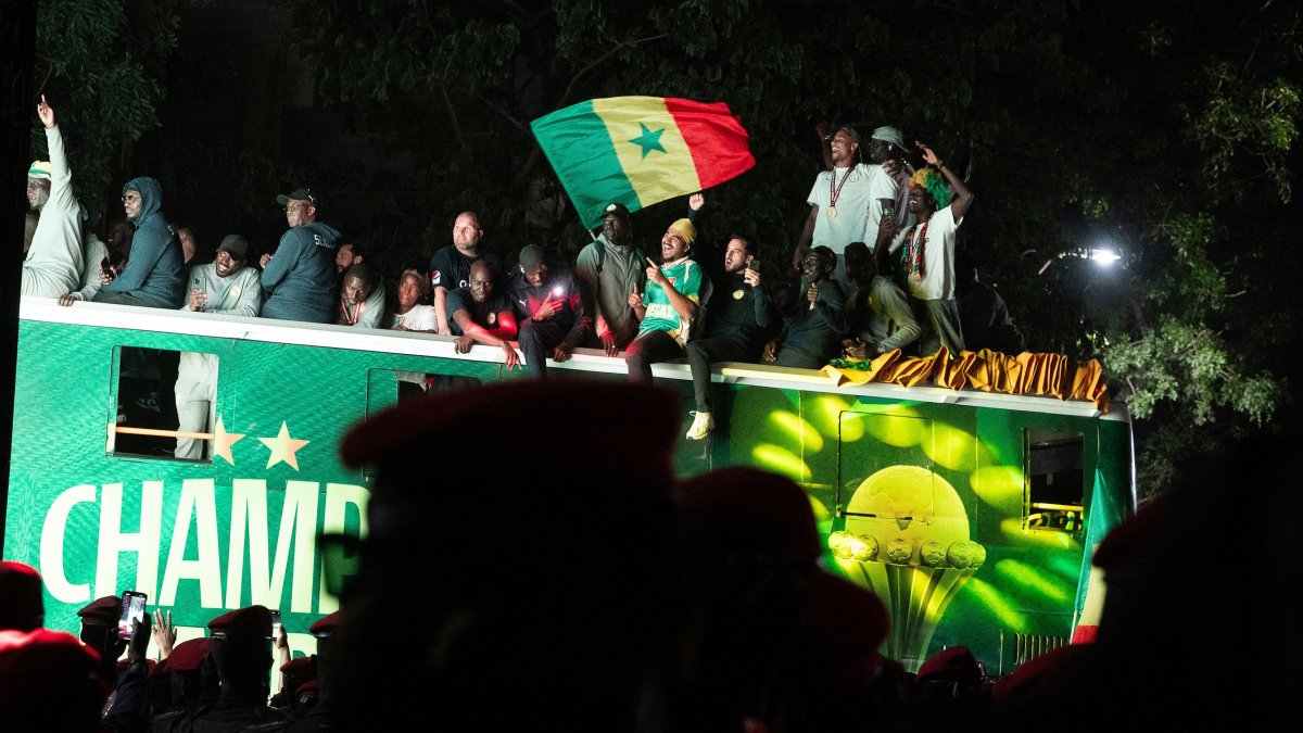 Senegal's Football Team players celebrate winning the Africa Cup of Nations (AFCON) atop an open bus during a trophy parade, Dakar, Senegal, Jan. 20, 2026. (AFP Photo)