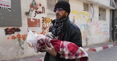 Khalid Abu Jarad holds the body of his 3-month-old niece, Shaza Abu Jarad, who, according to the health ministry, died from hypothermia, Gaza City, Palestine, Jan. 20, 2026. (AP Photo)