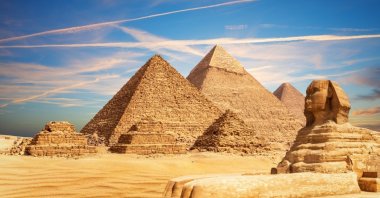 The Pyramids rise from the desert sands in Giza, Egypt. (Shutterstock Photo)