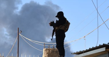 A member of the Syrian security forces stands in front of the gate of the al-Hol camp, in Hassakeh province, Syria, Jan. 21, 2026. (EPA Photo)