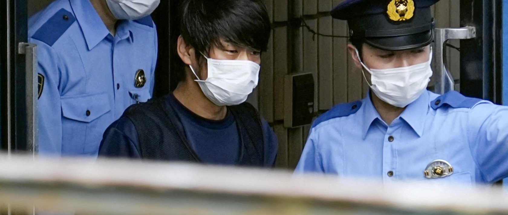 Tetsuya Yamagami, suspected of killing former Japanese Prime Minister Shinzo Abe, is escorted by police officers as he is taken to prosecutors, Nara, western Japan, July 10, 2022. (Reuters Photo)