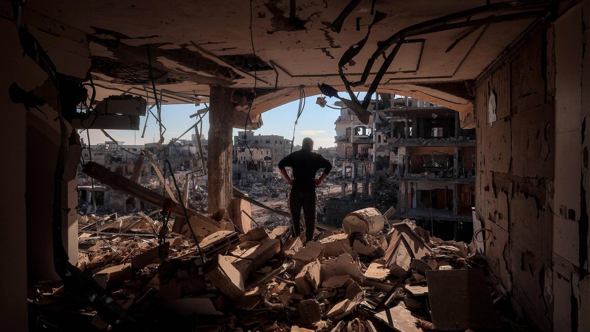 A man stands on an elevated floor in a heavily damaged building without walls, Rafah, Gaza Strip, Jan. 21, 2025. (AFP Photo)