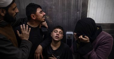 Family members of 13-year-old Moatasem mourn beside his body at Nasser Hospital, Khan Younis, Gaza Strip, Palestine, Jan. 21, 2026. (EPA Photo)