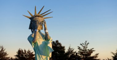 A sculpture depicting the Statue of Liberty covering her eyes stands, as demonstrators protest against U.S. immigration policies, Hudson, Colorado, U.S., Jan. 21, 2026. (Reuters Photo)