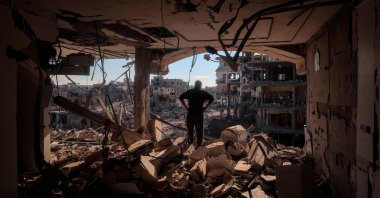 A man stands on an elevated floor in a heavily damaged building without walls, Rafah, Gaza Strip, Jan. 21, 2025. (AFP Photo)