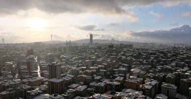 An aerial view of residential buildings with a backdrop of Çamlıca Tower on a snowy day, Istanbul, Türkiye, Jan. 19, 2026. (AA Photo)