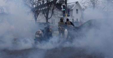 Federal agents detain a person while they're surrounded by tear gas used to deter protesters, as immigration enforcement continues after a U.S. Immigration and Customs Enforcement (ICE) agent fatally shot Renee Nicole Good on Jan. 7 during an immigration raid, Minneapolis, Minnesota, U.S., Jan. 21, 2026. (Reuters Photo)