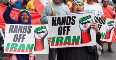 Protesters hold posters during a solidarity protest outside the U.S. embassy for the people of Venezuela, Iran and Palestine, in Cape Town, South Africa, Jan. 22, 2026. (Reuters Photo)