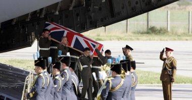 The coffin containing Joseph David Windall of the British Royal Marines is carried from a C17 plane at RAF Kinloss, in Scotland, Sept. 12, 2006. (AFP File Photo)