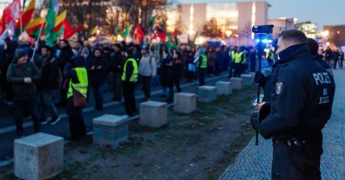 A police officer films pro-PKK/YPG protestors that walk in front of the Chancellery during a protest against the visit of Syrian President Ahmed Al Sharaa to Berlin, in Berlin, Germany, Jan. 19, 2026. (EPA Photo)