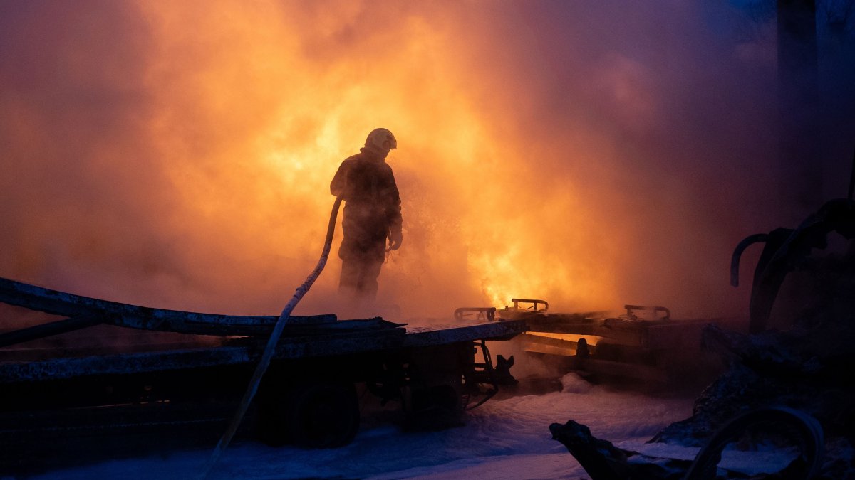 A Ukrainian emergency personnel works to extinguish a fire at the site of an air attack amid the Russian invasion, in Kyiv, Ukraine, Jan. 24, 2026. (AFP Photo)