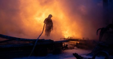 A Ukrainian emergency personnel works to extinguish a fire at the site of an air attack amid the Russian invasion, in Kyiv, Ukraine, Jan. 24, 2026. (AFP Photo)