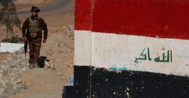 A member of the Iraqi border forces patrols along a concrete wall on the Iraqi-Syrian border, following recent events in Syria, in the town of al-Baghuz in the Al-Qaim district of western Iraq, Jan. 21, 2026. (AFP Photo)