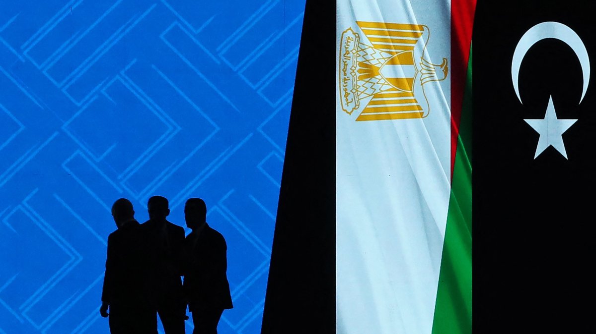Delegates are silhouetted against a digital screen on the inaugural day of the Libya Energy and Economic Summit at the Tripoli International Conference Center, Tripoli, Libya, Jan. 24, 2026. (AFP Photo)