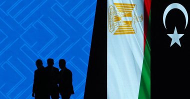 Delegates are silhouetted against a digital screen on the inaugural day of the Libya Energy and Economic Summit at the Tripoli International Conference Center, Tripoli, Libya, Jan. 24, 2026. (AFP Photo)