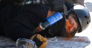 A protester is pepper sprayed at close range while being detained near the site of the fatal shooting of 37-year-old Alex Pretti by federal agents in Minneapolis, U.S., Jan. 24, 2026. (AP Photo)