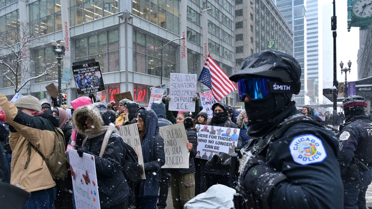 Protesters wave flags and placards condemning the killing of 37-year-old ICU nurse Alex Pretti by federal immigration agents in Minneapolis, Chicago, U.S., Jan. 25, 2026. (AA Photo)