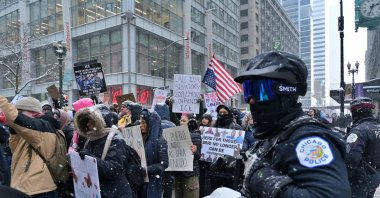 Protesters wave flags and placards condemning the killing of 37-year-old ICU nurse Alex Pretti by federal immigration agents in Minneapolis, Chicago, U.S., Jan. 25, 2026. (AA Photo)