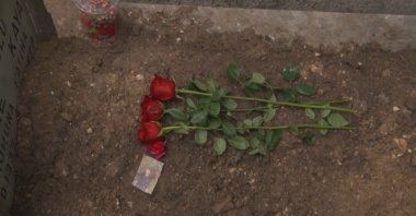 Roses lie on the grave of Atlas Çağlayan as family members and friends visit his grave in the Çağlayan district of Istanbul, Türkiye, Jan. 17, 2026. (IHA Photo)