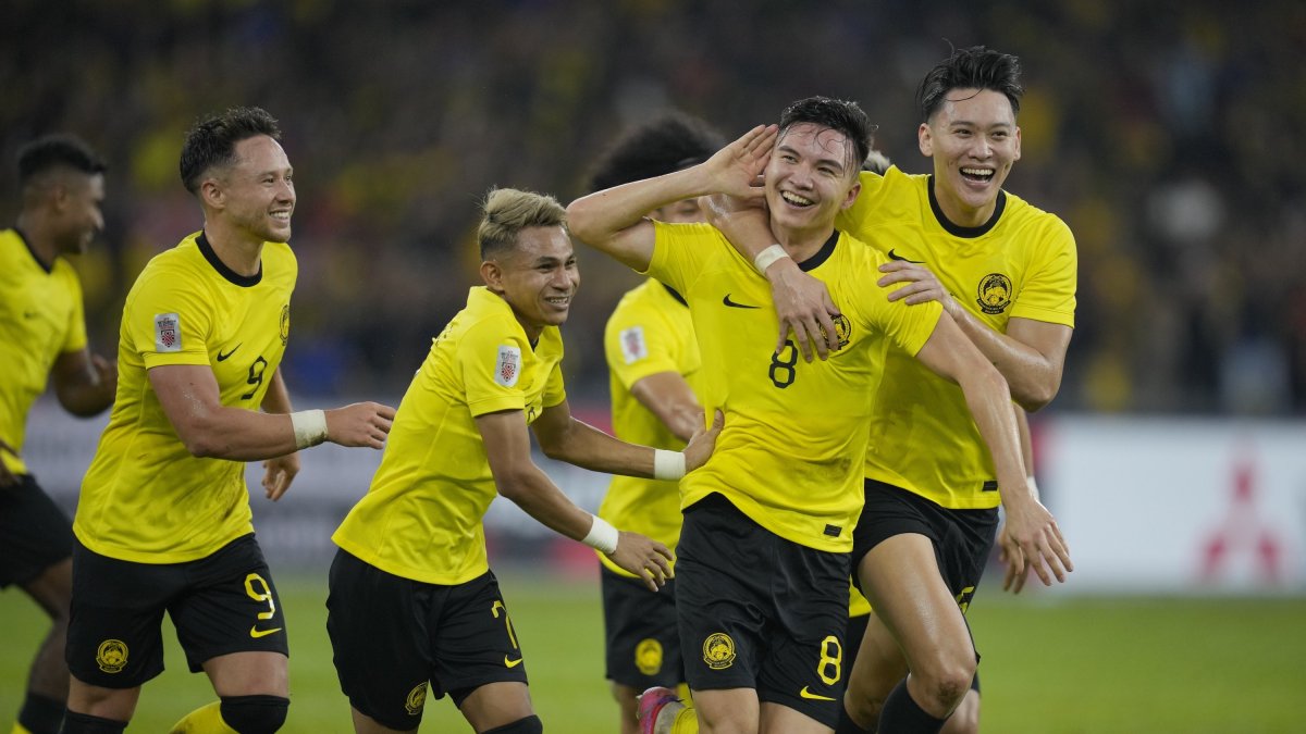 Malaysia's Stuart John Wilkin (C) celebrates after he scored the second goal for Malaysia during a match against Singapore during the ASEAN Football Federation (AFF) Mitsubishi Electric Cup 2022 Group B match in Bukit Jail stadium, Kuala Lumpur, Malaysia, Jan. 3, 2023. (AP Photo)