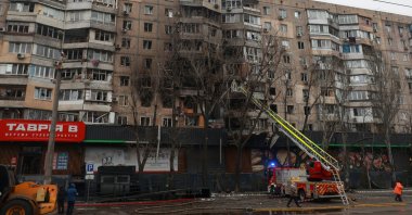 A firefighter works at the site of an apartment building hit during overnight Russian drone strikes, amid Russia's attack in Odesa, Ukraine, Jan. 27, 2026. (Reuters Photo)