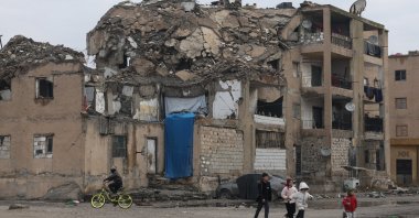 Children play in a damaged residential building, Raqqa, Syria, Jan. 24, 2026. (AP Photo)