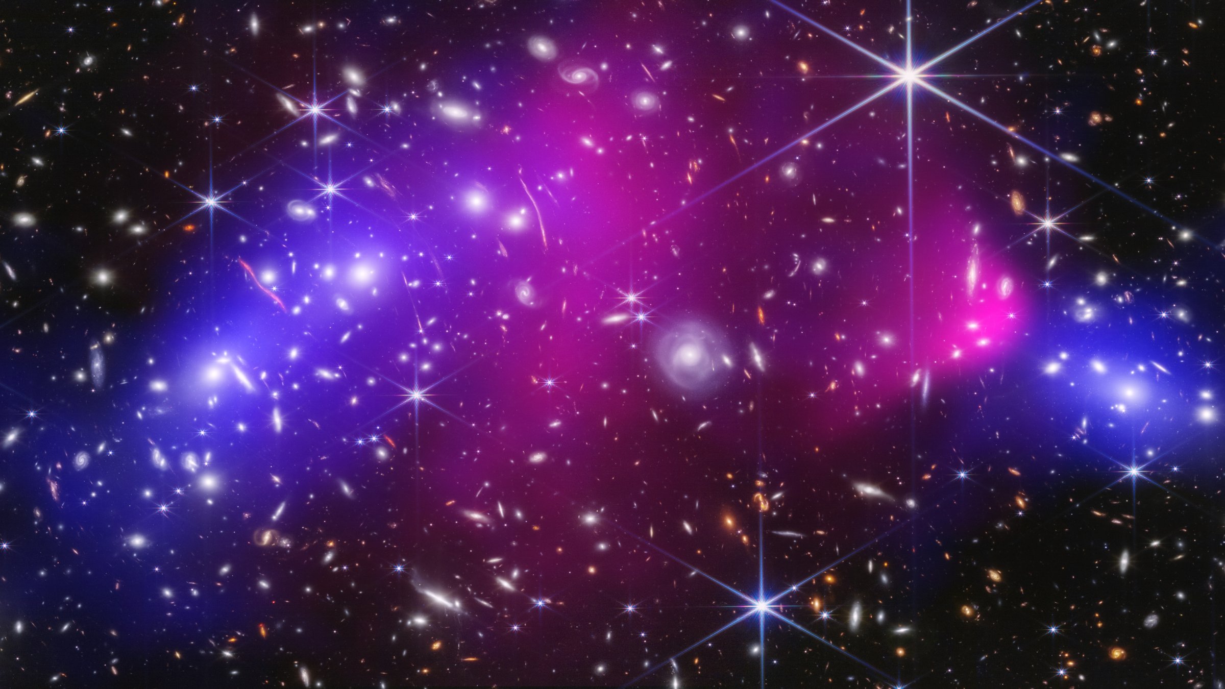 This NASA image shows two massive galaxy clusters previously captured by NASA's James Webb Space Telescope and Chandra X-ray Observatory, with areas of possible dark matter in blue. (AP Photo)