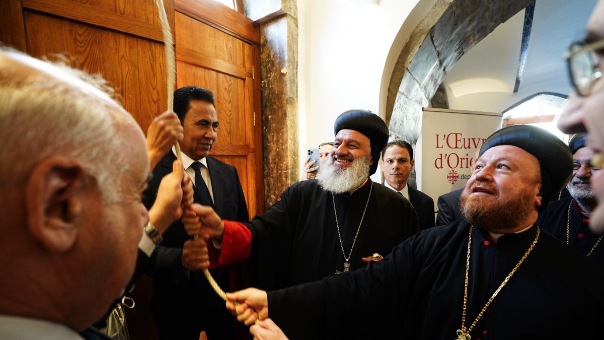 (L-R) Minister of Culture, Tourism and Antiquities Ahmed Fakkak Al-Badrani, Governor of Nineveh Abdul-Qader Al-Dakhil, Patriarch Mor Ignatius Aphrem II of the Syriac Orthodox Church, and Syriac Orthodox Archbishop Mor Nicodemus Daoud Sharaf ring the bell of St. Thomas Syriac Orthodox Church during the reopening ceremony following its reconstruction, San Jose, U.S., Oct. 15, 2025. (Getty Images Photo)