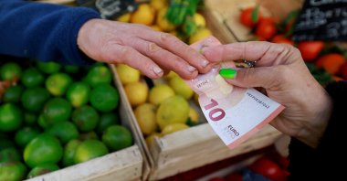 A shopper pays with a 10-euro banknote at a local market in Aix-en-Provence, France, Jan. 16, 2025. (Reuters Photo)