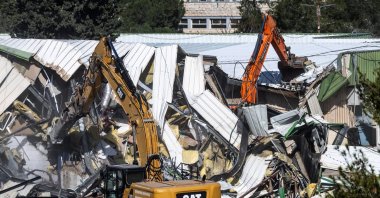 Israeli bulldozers demolish parts of the headquarters of the United Nations Relief and Works Agency (UNRWA) in the east Jerusalem neighborhood of Sheikh Jarrah, Jan. 20, 2026.  (EPA Photo)