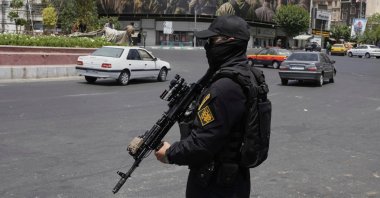 A member of Iran's Revolutionary Guard stands guard at Enqelab-e-Eslami (Islamic Revolution) square in downtown Tehran, Iran, June 24, 2025. (AP Photo)