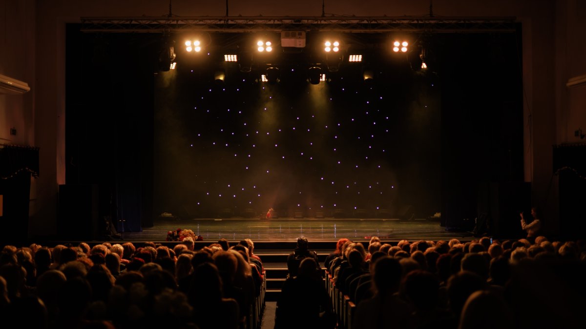 An empty theater stage, illuminated by spotlights and shrouded in smoke before the performance. (Shutterstock Photo)