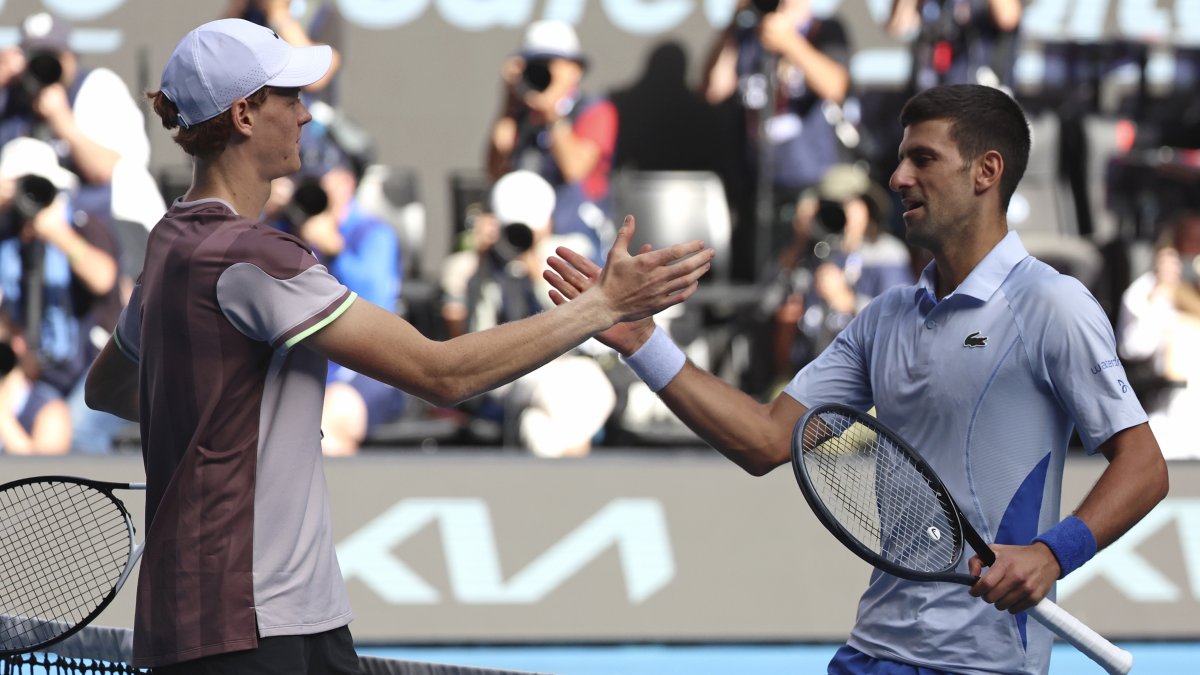 Italy's Jannik Sinner (L) is congratulated by Serbia's Novak Djokovic following their semifinal at the Australian Open tennis championships at Melbourne Park, Melbourne, Australia, Jan. 26, 2024. (AP Photo)