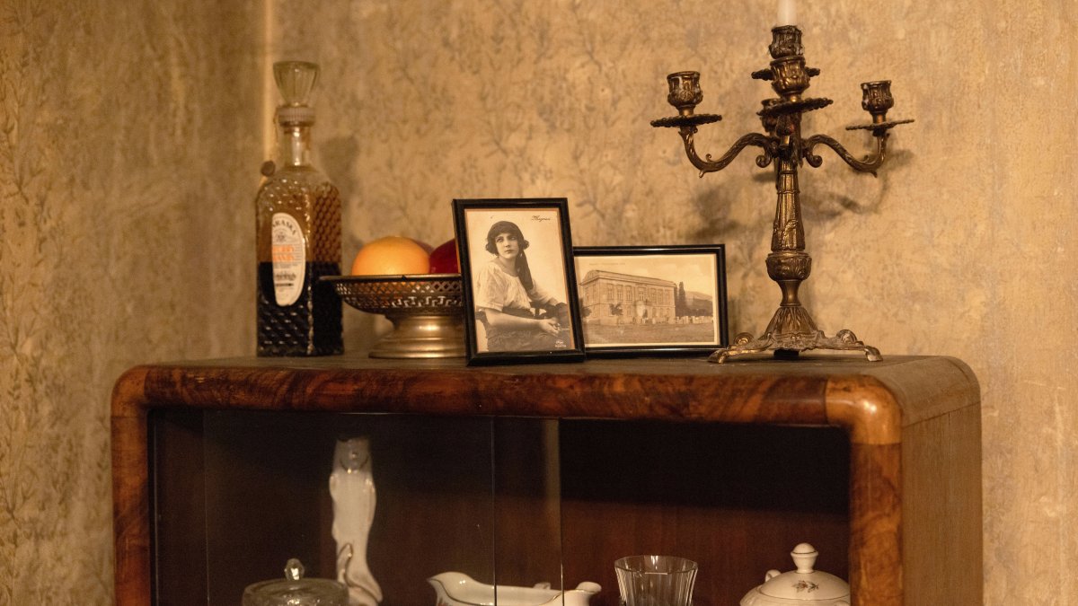 Old photos and other objects stand on a piece of furniture in an old villa used for theater performances by an independent theater production, Belgrade, Serbia, Jan. 18, 2026. (AP Photo)