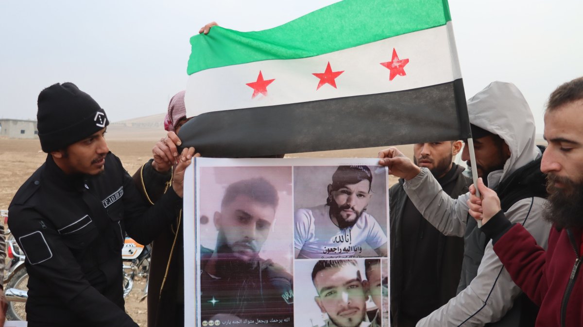 Relatives of civilians killed by the YPG terrorist group hold portraits of their loved ones during a protest, Aleppo, Syria, Jan. 28, 2026. (AA Photo)