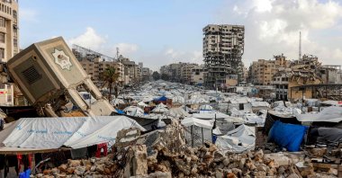 Tents and shelters are seen at a camp for displaced people around a building destroyed by Israel’s attacks, Gaza City, Palestine, Jan. 28, 2026. (AFP Photo)