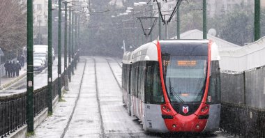 Snowfall covers the tramway line around the Cevizlibağ area in Istanbul, Türkiye, Jan. 19, 2026. (AA Photo) 
