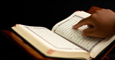 A person reads the Quran. (Shutterstock Photo)