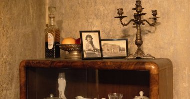 Old photos and other objects stand on a piece of furniture in an old villa used for theater performances by an independent theater production, Belgrade, Serbia, Jan. 18, 2026. (AP Photo)