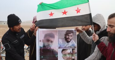 Relatives of civilians killed by the YPG terrorist group hold portraits of their loved ones during a protest, Aleppo, Syria, Jan. 28, 2026. (AA Photo)