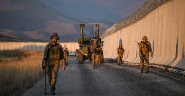 Turkish soldiers patrol near the border wall between Türkiye and Iran in the Van province, eastern Türkiye, Nov. 1, 2024. (AFP Photo)