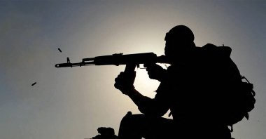 This handout picture provided by Iran&amp;#039;s Islamic Revolutionary Guards Corps (IRGC)&amp;#039;s official website Sepahnews on Jan. 24, 2025, shows an Iranian soldier firing an assault rifle during a military drill in the Gulf and southern Iran. (Photo by Sepah News via AFP)