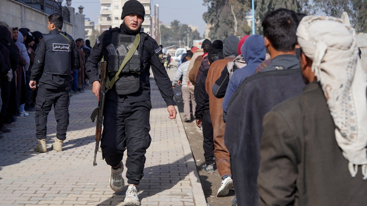Members of the PKK/YPG terrorist group line up to settle their status with the Syrian government, Raqqa, Syria, Jan. 27, 2026. (Reuters Photo)