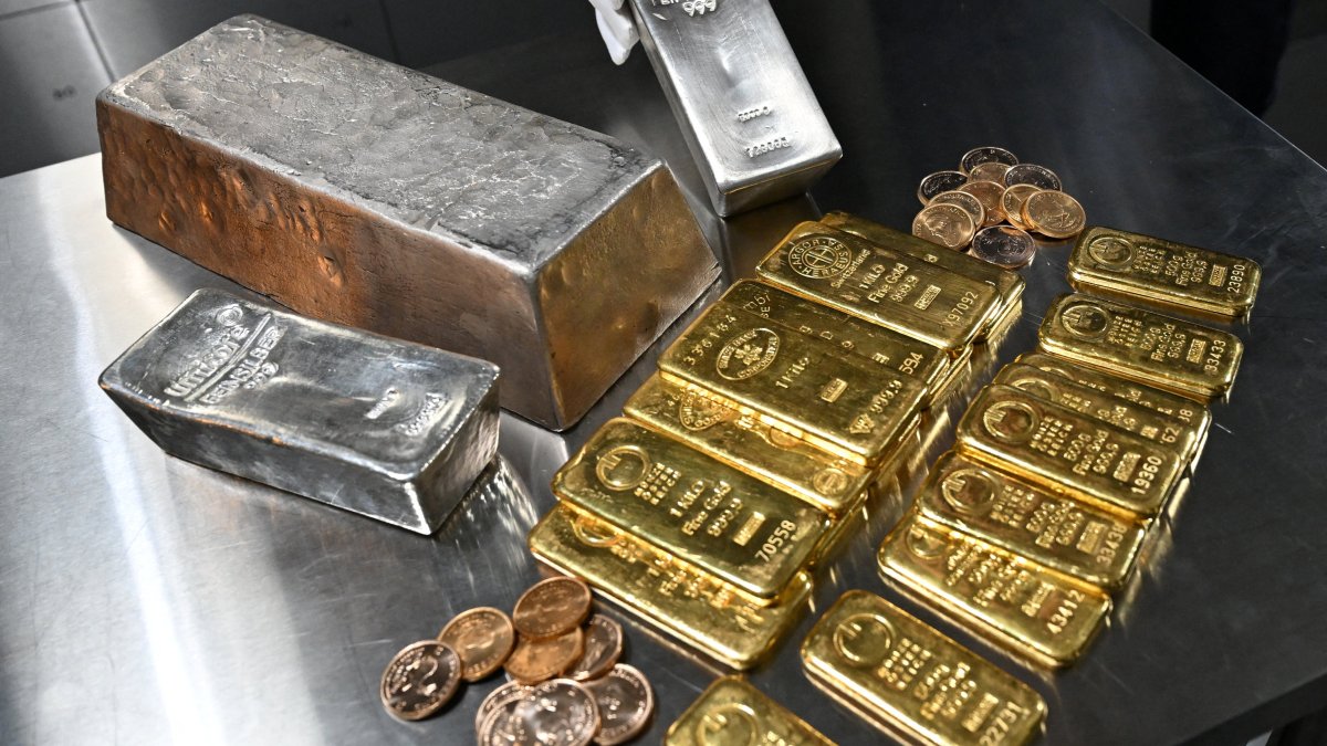 An employee shows a silver bar, as gold and silver bars of various values are stored in a safe deposit room in Munich, Germany, Jan. 28, 2026. (Reuters Photo)