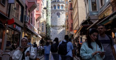 People walk on a small street that leads to the historical Galata Tower, Istanbul, Türkiye, April 25, 2025. (Reuters Photo)