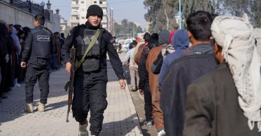 Members of the PKK/YPG terrorist group line up to settle their status with the Syrian government, Raqqa, Syria, Jan. 27, 2026. (Reuters Photo)