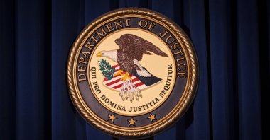 The Department of Justice logo is pictured on a wall after a news conference in New York, Dec. 5, 2013.  (Reuters File Photo)