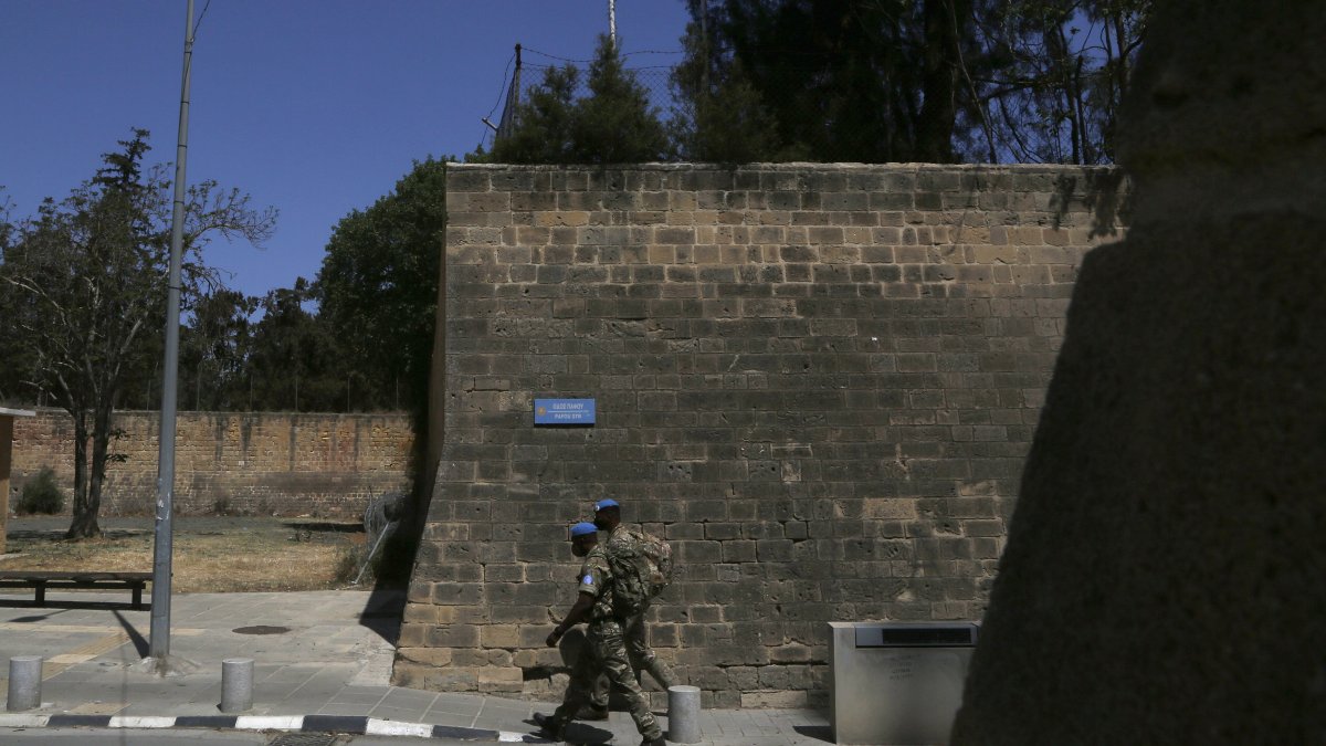 U.N peacekeepers walk by the Venice wall at the medieval core across the U.N buffer zone, in the divided capital Lefkoşa (Nicosia), April 26, 2021. (AP Photo)
