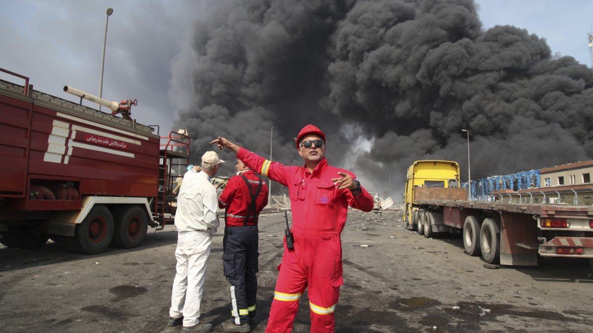 In this photo provided by Islamic Republic News Agency (IRNA) firefighters work as black smoke rises in the sky after a massive explosion rocked a port near the southern city of Bandar Abbas, Iran, April 26, 2025. (AP Photo)