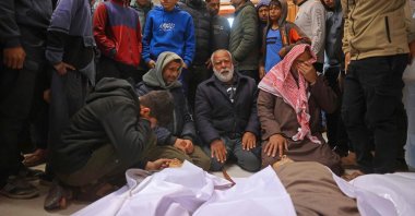 Mourners weep next to the bodies of Palestinians, who were reportedly killed by an Israeli air strike, in Khan Yunis, southern Gaza Strip, Jan. 31, 2026. (AFP Photo)